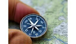 Compass held over a topographical map